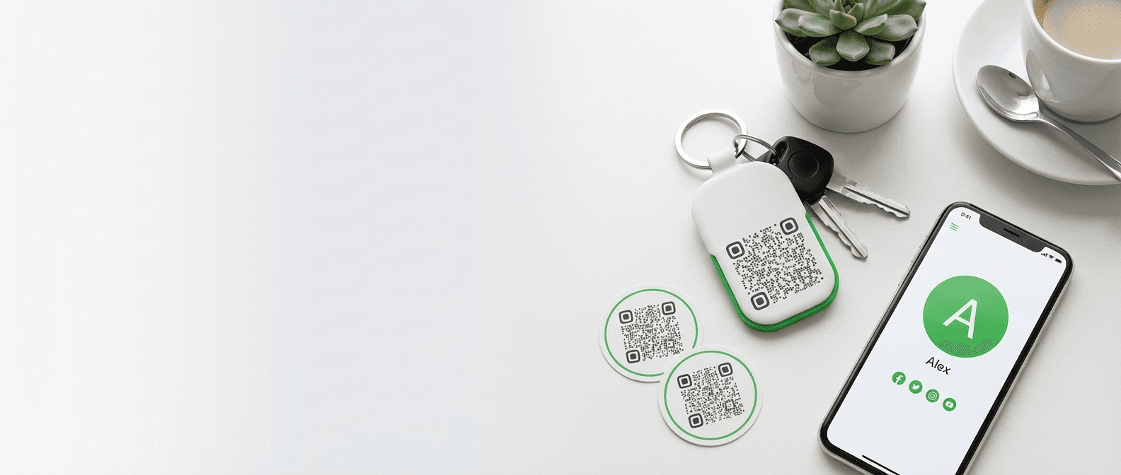 QR Me product flat lay with keychain, stickers, and phone